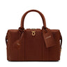 Brown leather handbag with visible brand tag on a white background