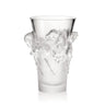 Clear glass vase with artistic carvings on a white background