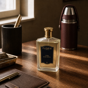Floris 89 EDT on a wooden surface with a pen and Ettinger Bottle in the background