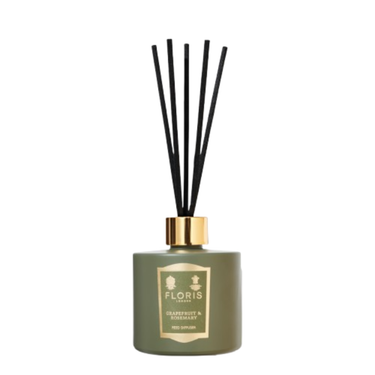 Green Floris diffuser bottle with black sticks on a white background